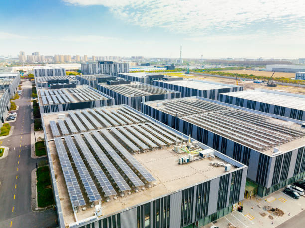 Aerial view of solar panels on factory roof.